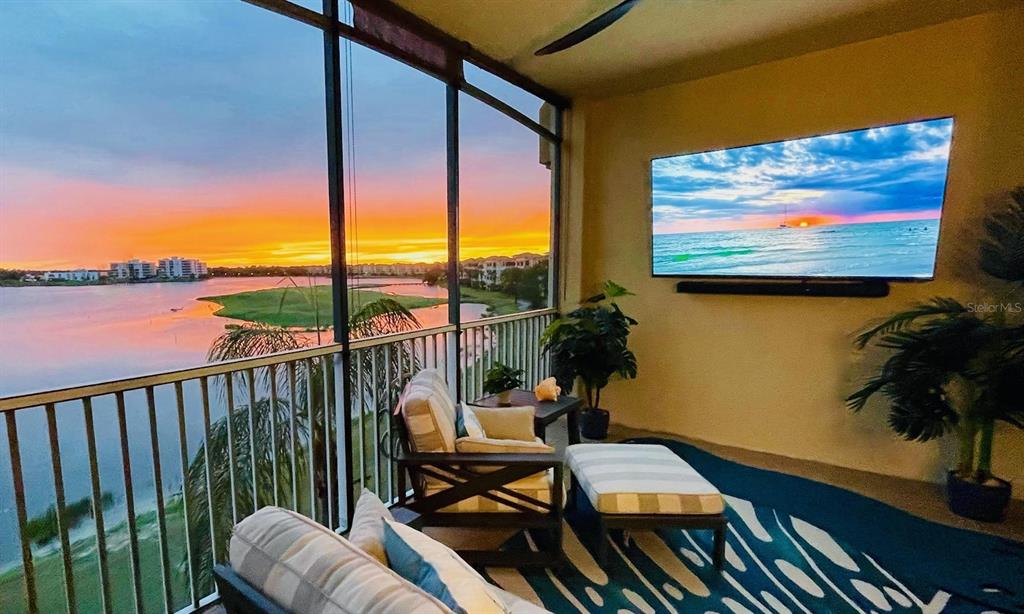 a view of a balcony with furniture and floor to ceiling window