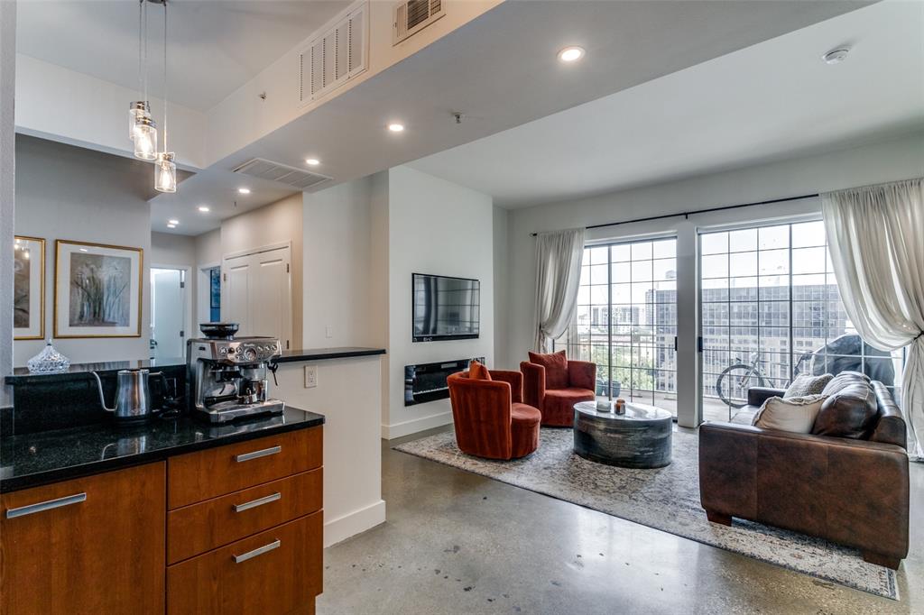 a large living room with furniture a flat screen tv and a large window