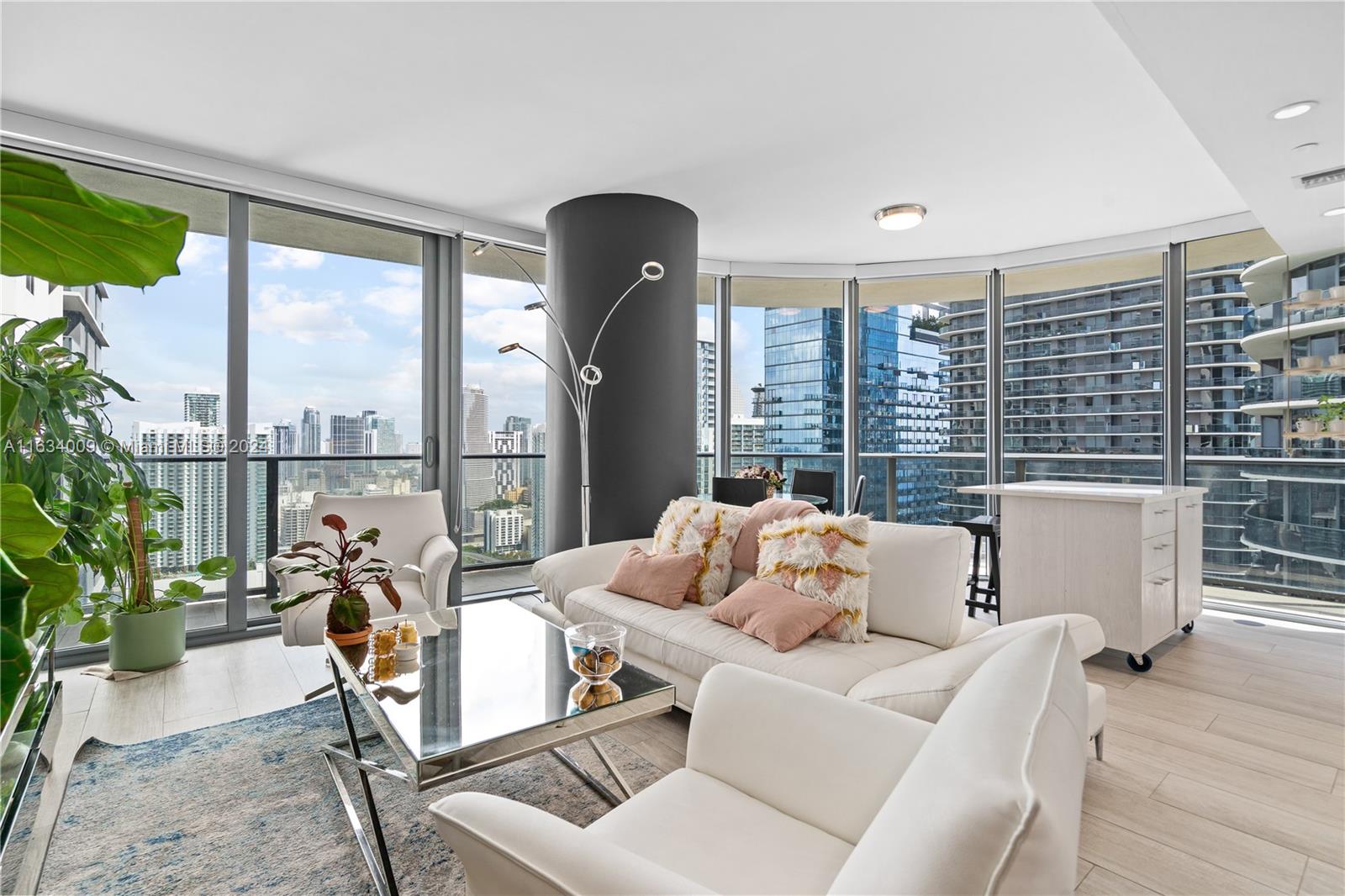 a living room with furniture and a floor to ceiling window