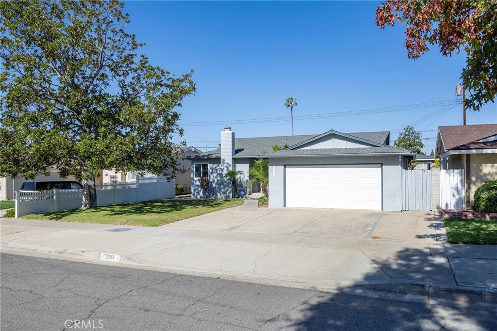 a view of a house with a yard and garage