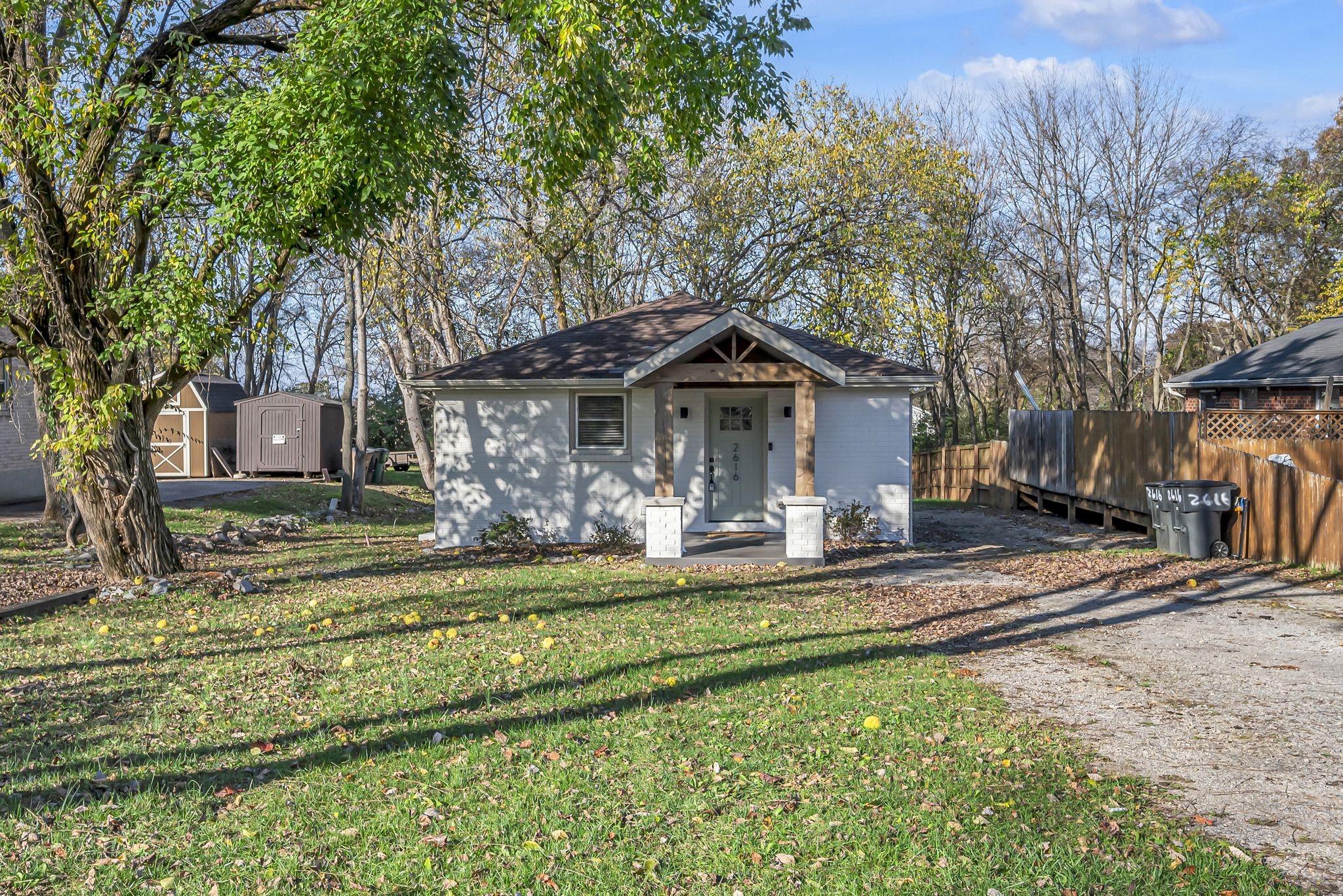 a front view of a house with a yard table and chairs