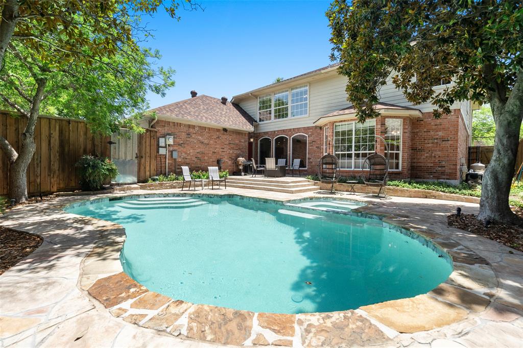 a swimming pool with outdoor seating and yard