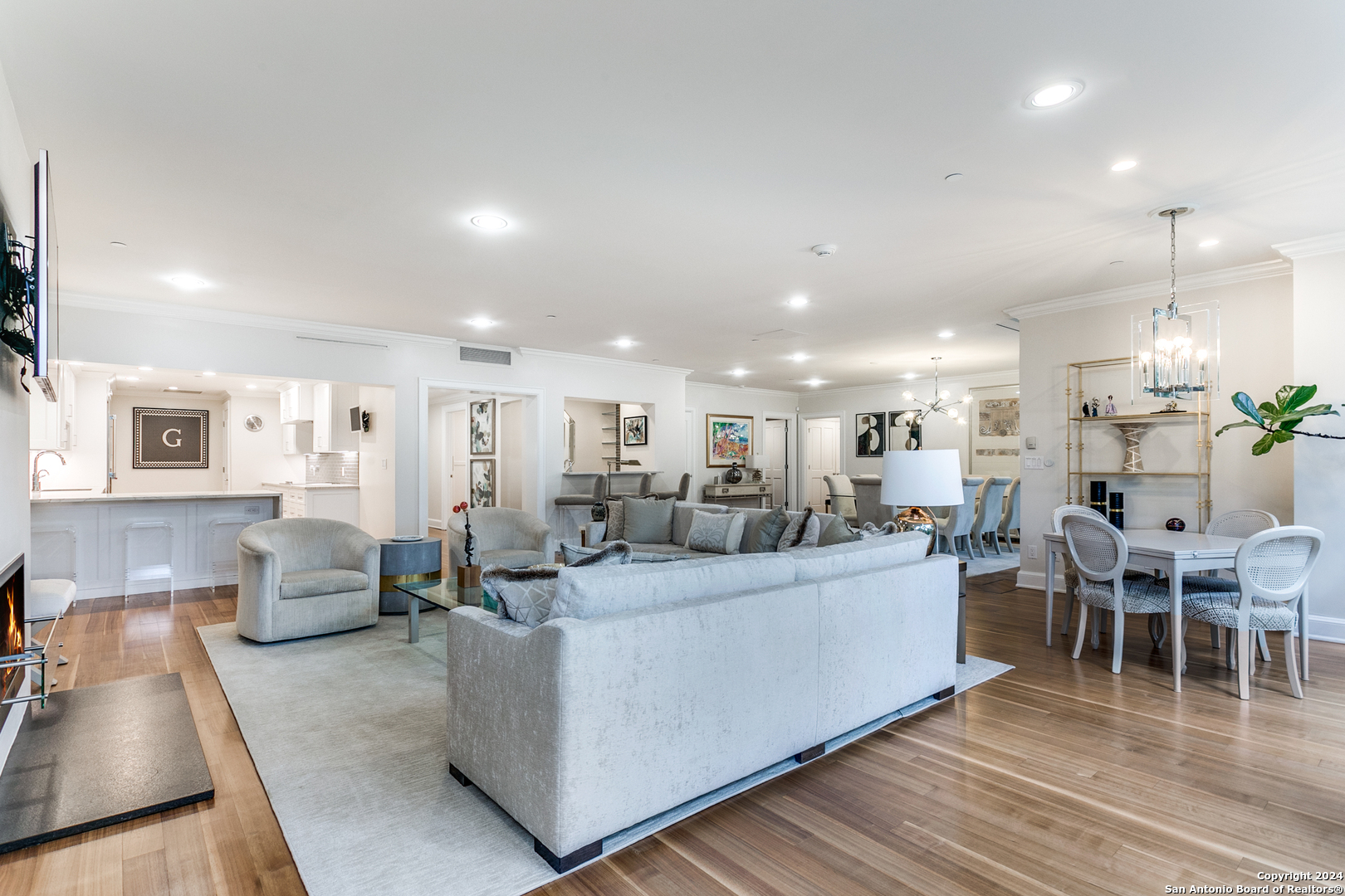 a living room with lots of furniture and a wooden floor