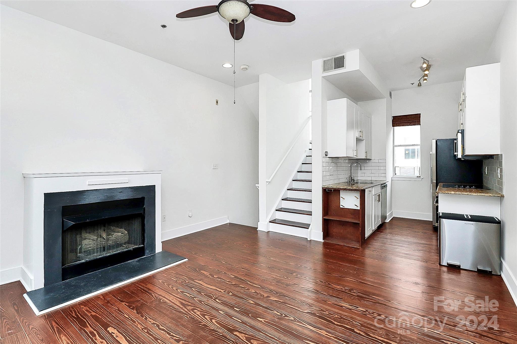 a view of kitchen with furniture and fireplace