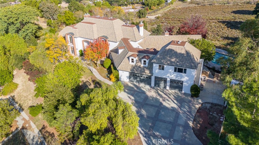 a aerial view of a house with a yard and plants