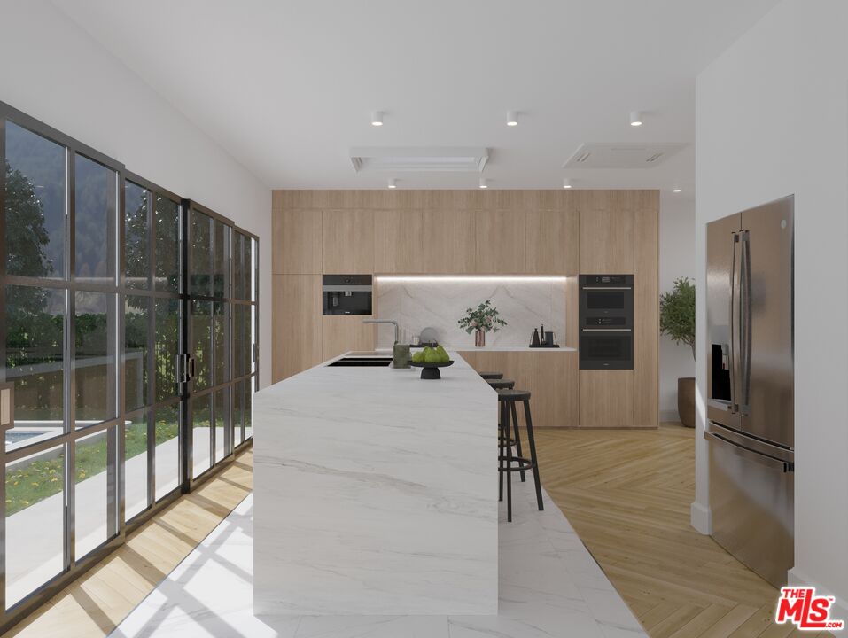 a view of kitchen with furniture and refrigerator