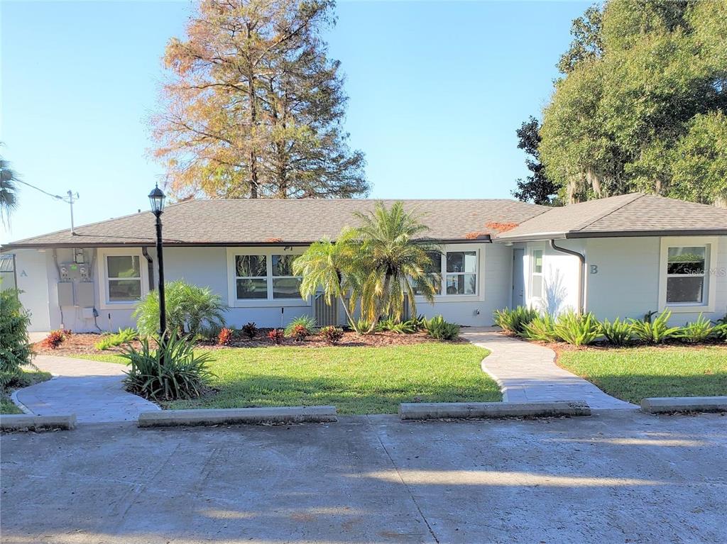 a front view of a house with a yard and porch