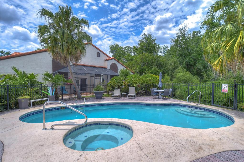 a swimming pool with outdoor seating and yard