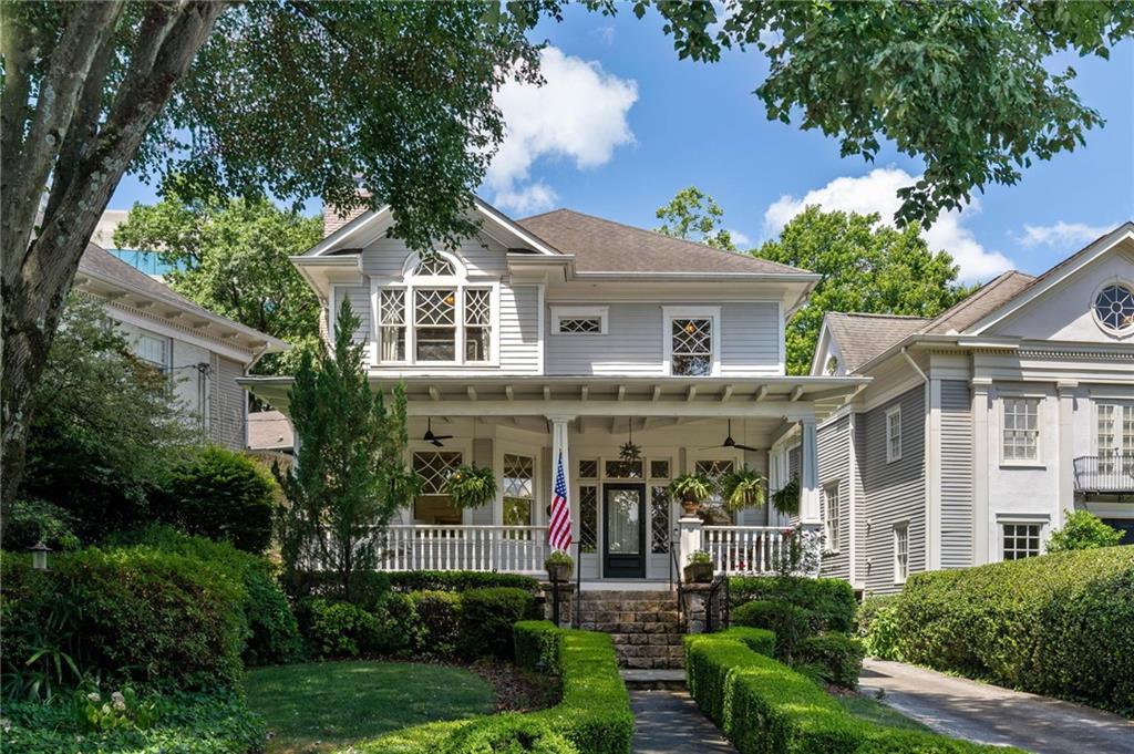 a front view of a house with plants and trees