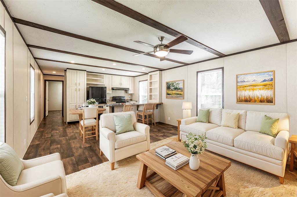 a living room with furniture and a ceiling fan