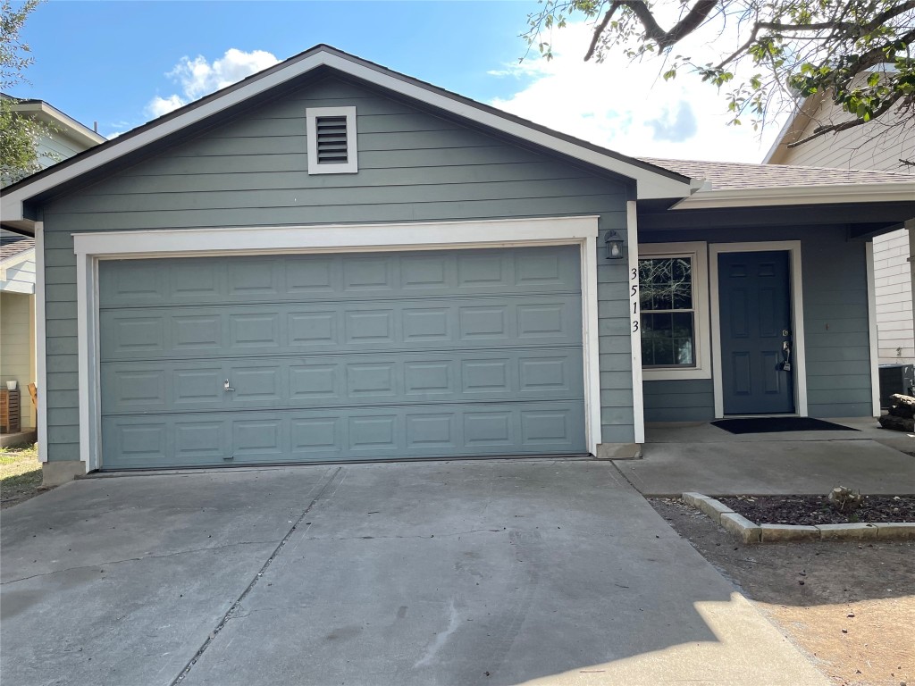 a front view of a house with garage