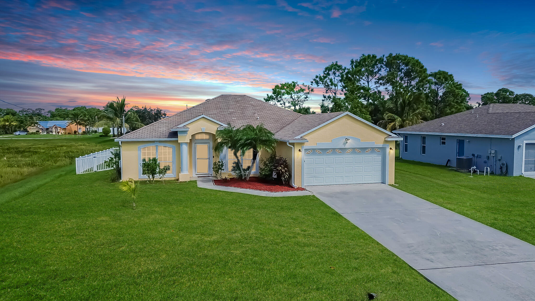 a front view of house with yard and green space