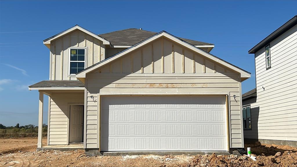 a front view of a house with garage