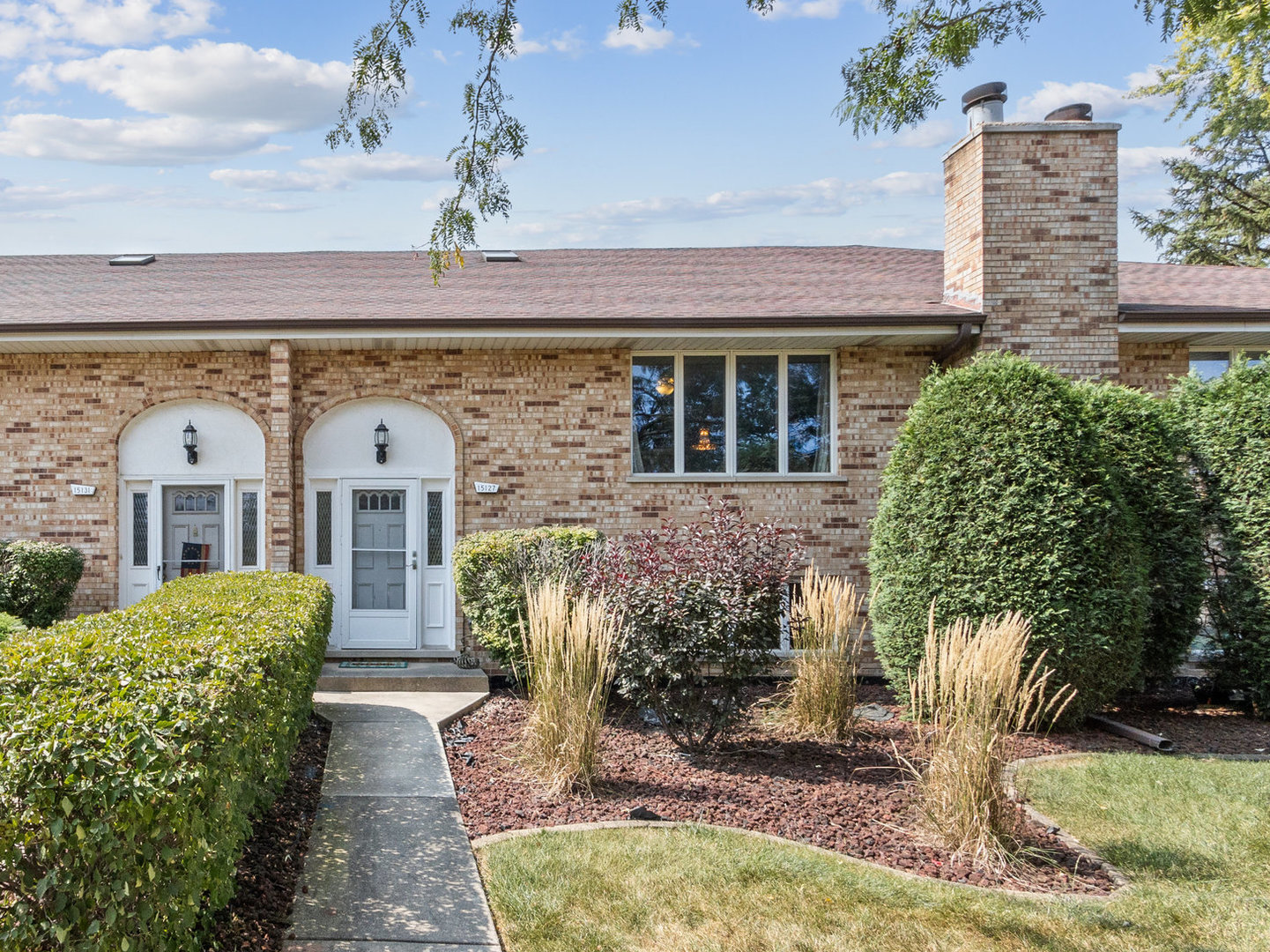 a front view of a house with garden