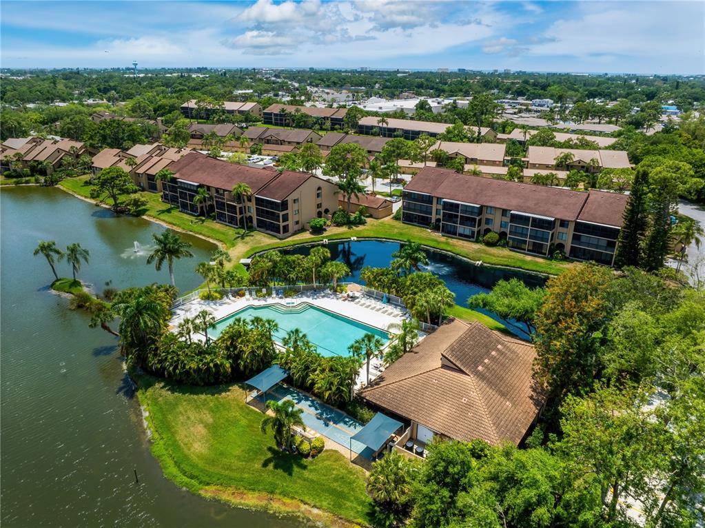 an aerial view of residential houses with outdoor space and lake view