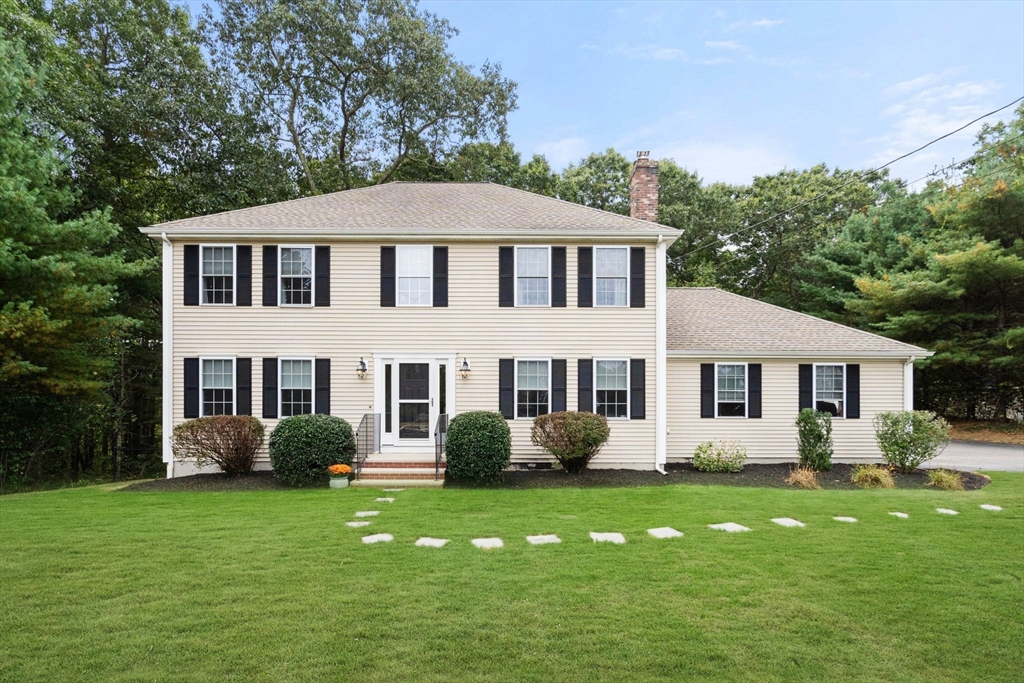 a front view of a house with a garden