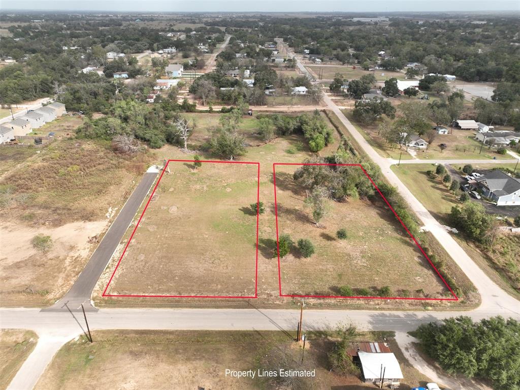 an aerial view of residential houses with yard