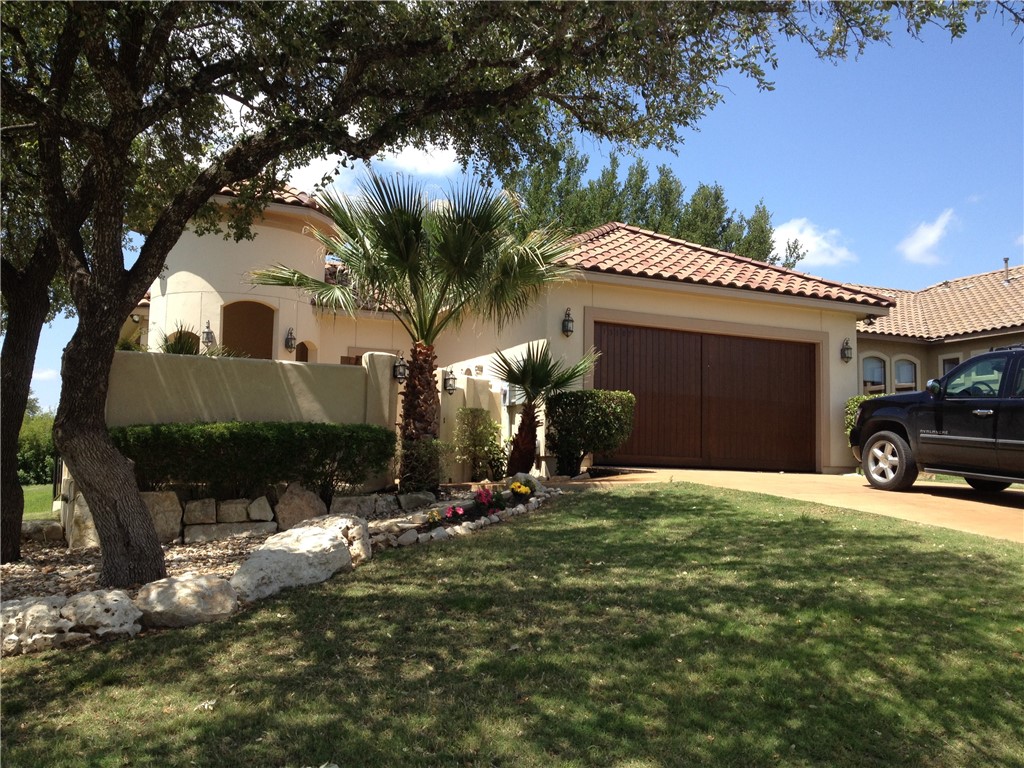 a view of a house with a yard garage and chair