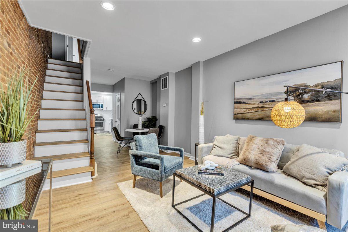 a living room with furniture and wooden floor