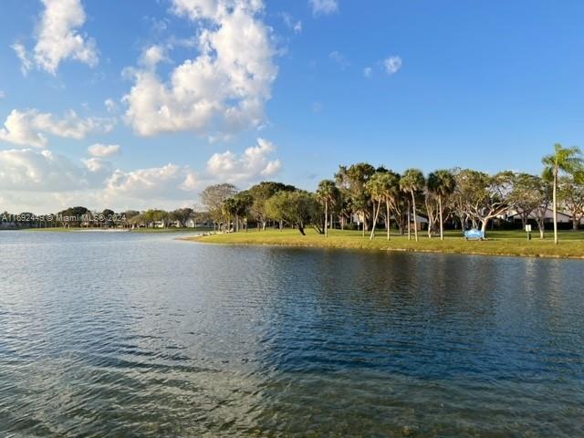 a view of a lake with houses in the background