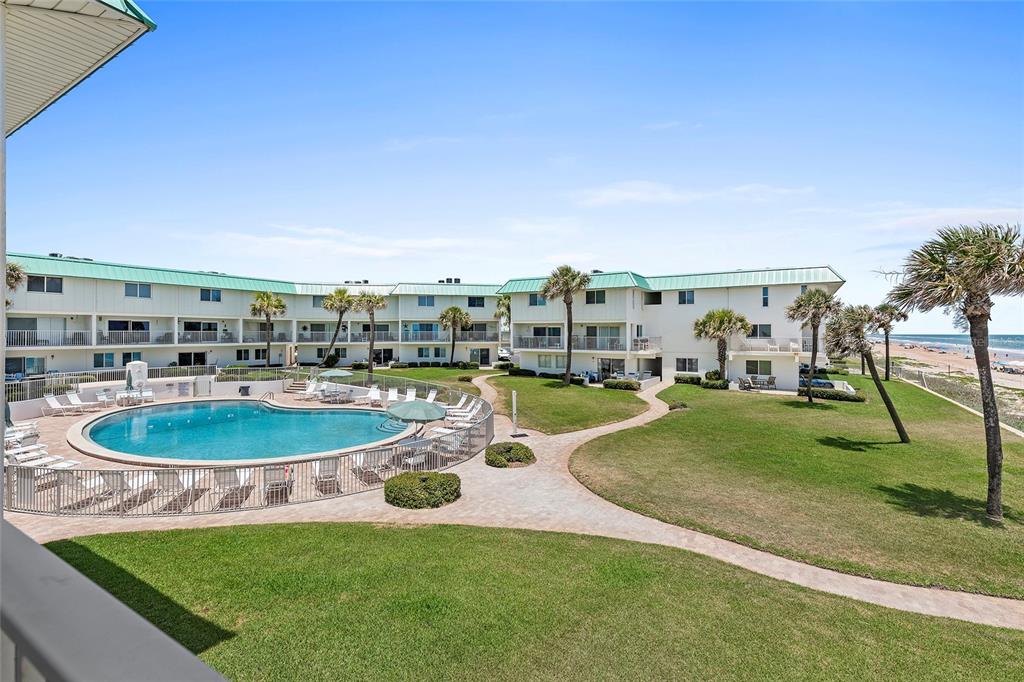 a view of a swimming pool with a yard