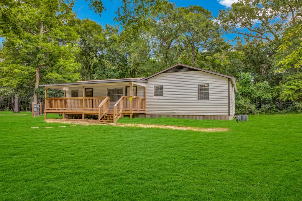 a view of a house with a backyard