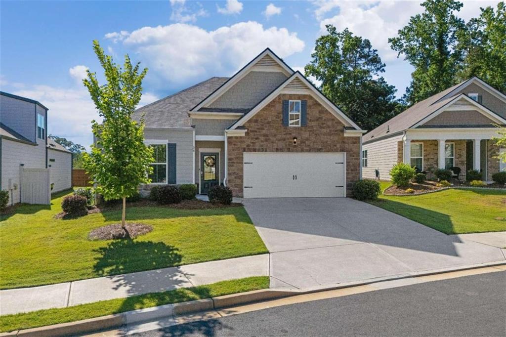 a front view of a house with a yard and garage