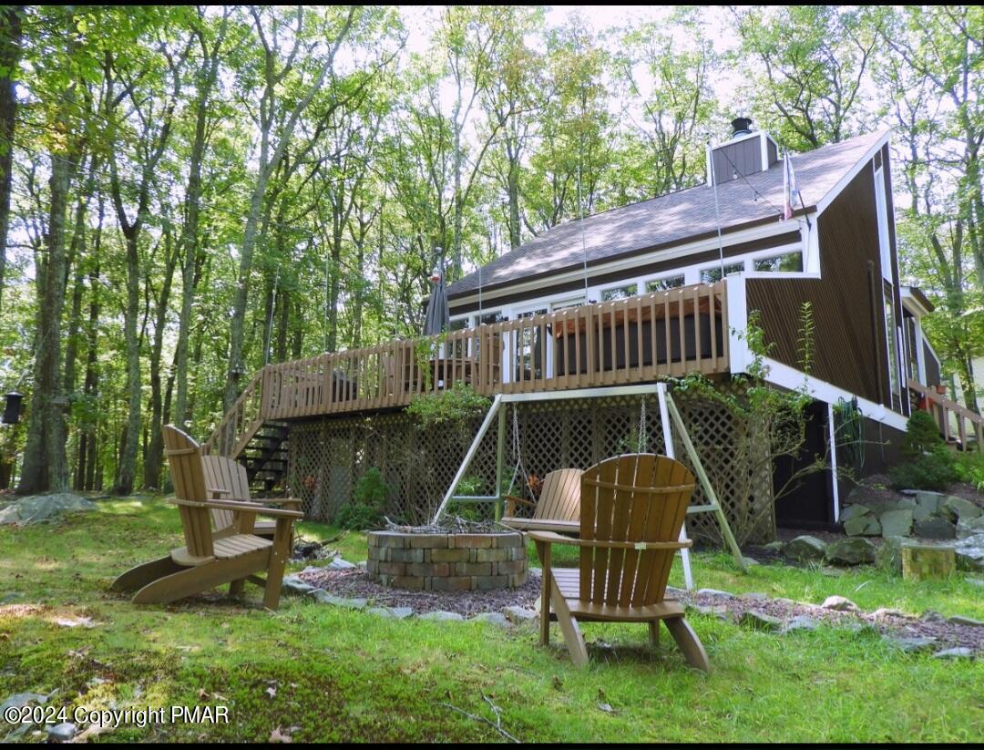 a view of backyard with a table and chairs and a slide