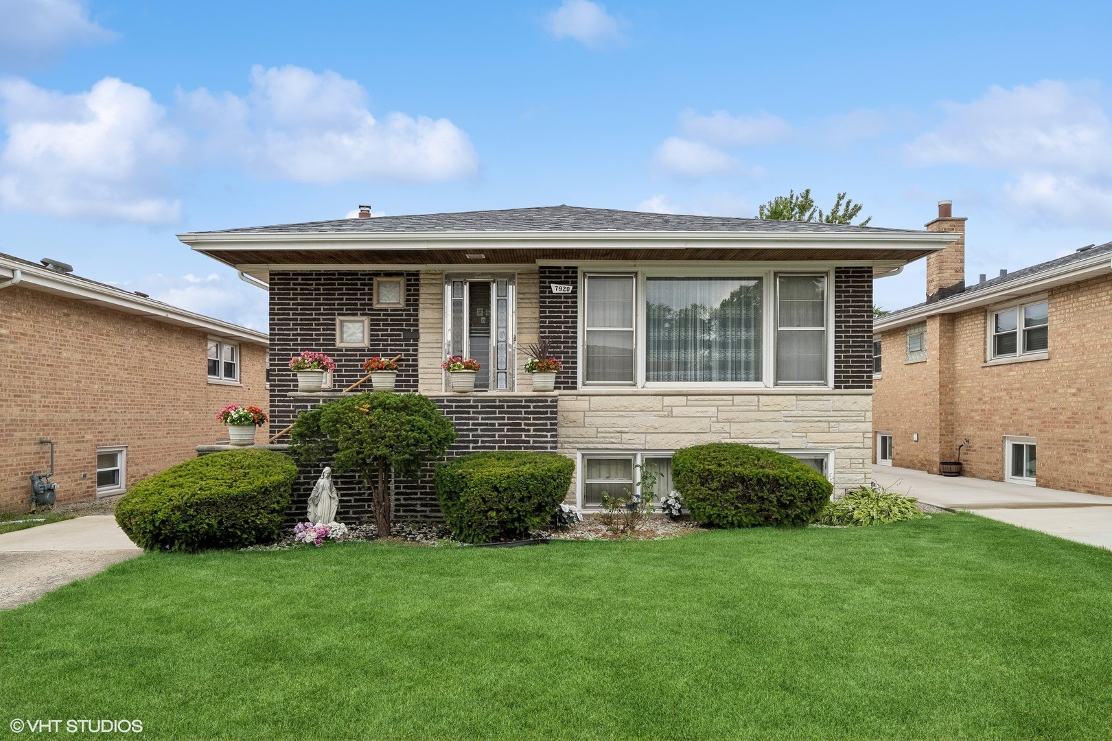 a front view of a house with a garden