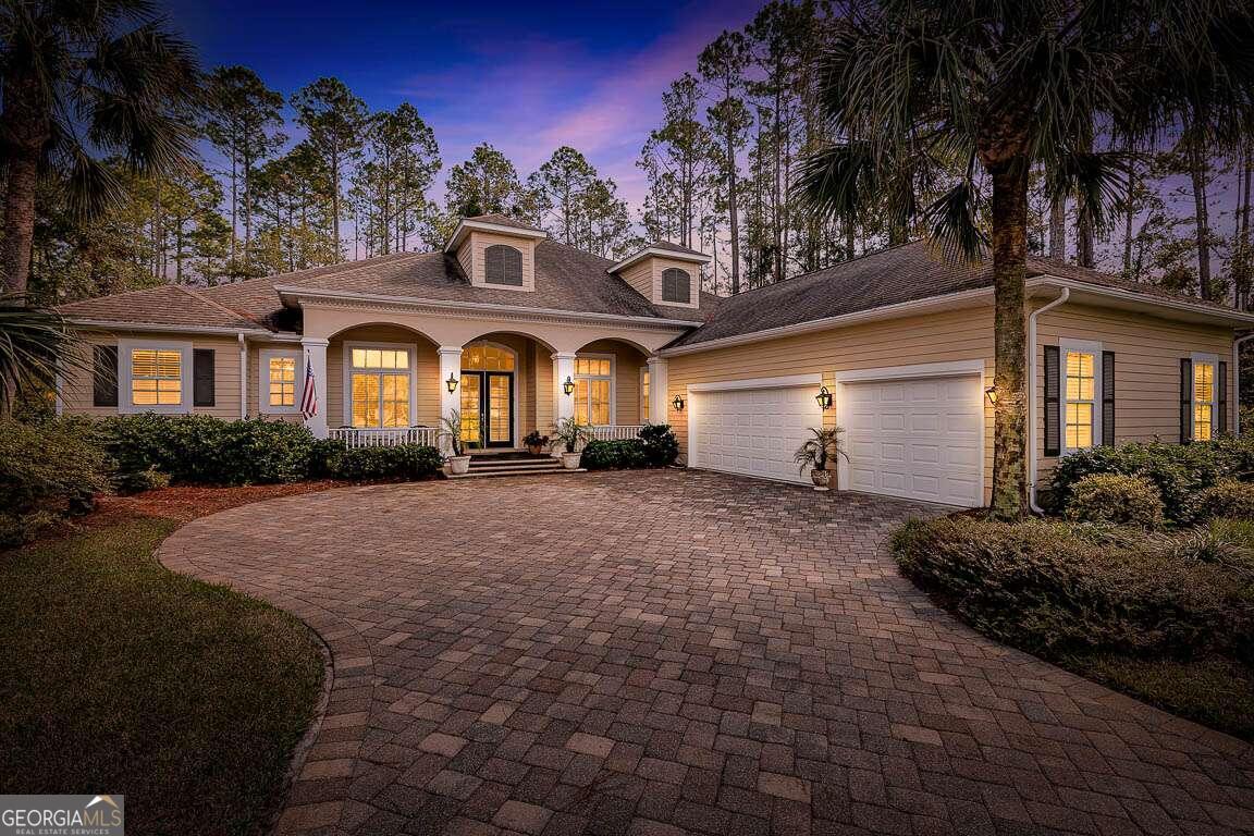 a front view of a house with a garden