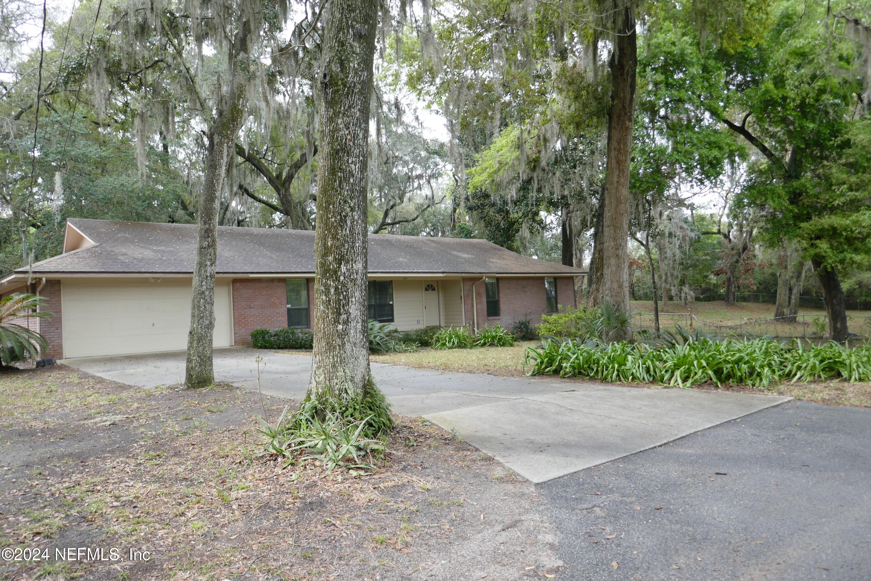 a front view of a house with a yard and a garage