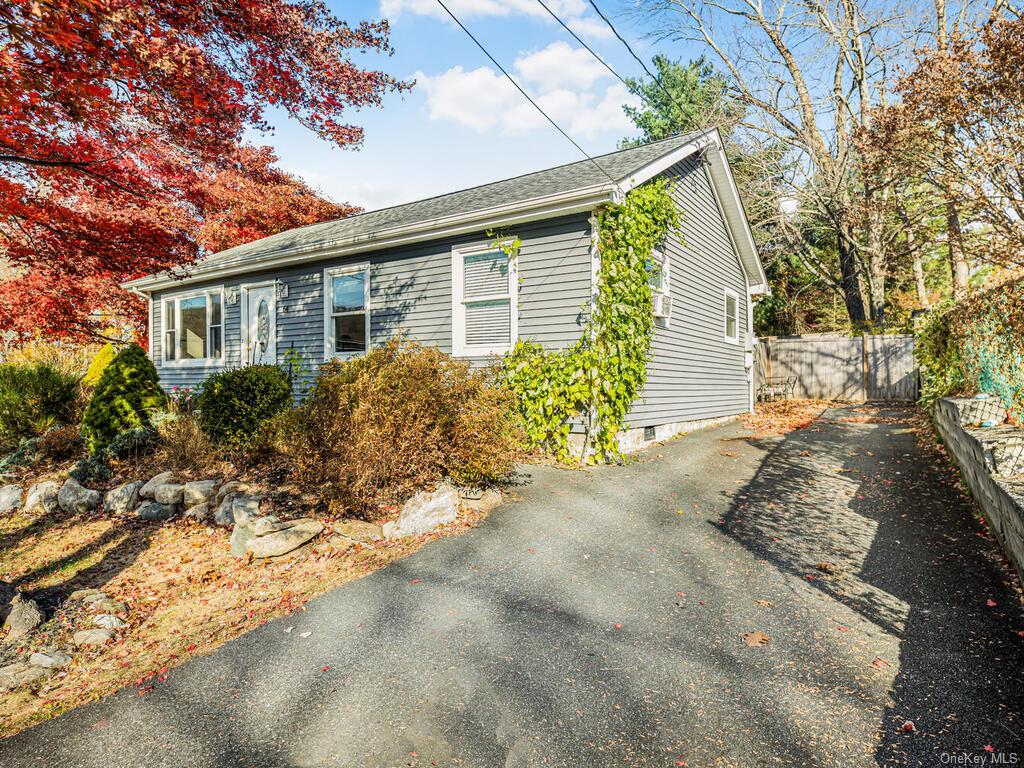 a front view of house with yard and trees around