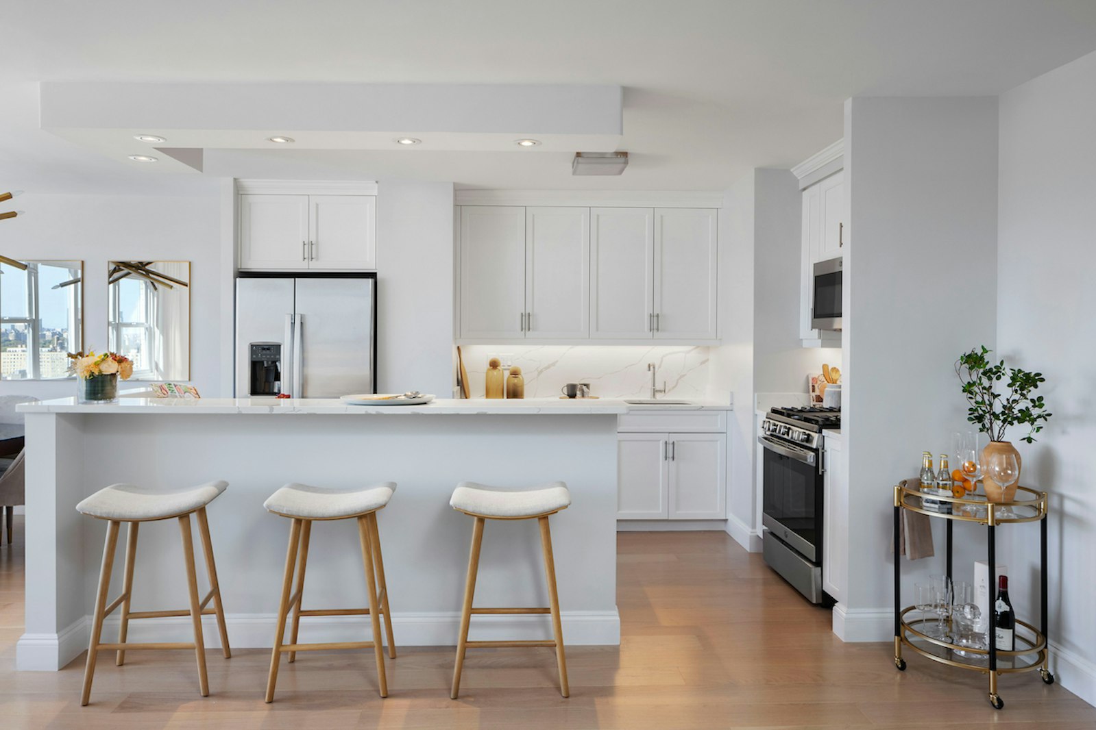 a kitchen with cabinets and chairs