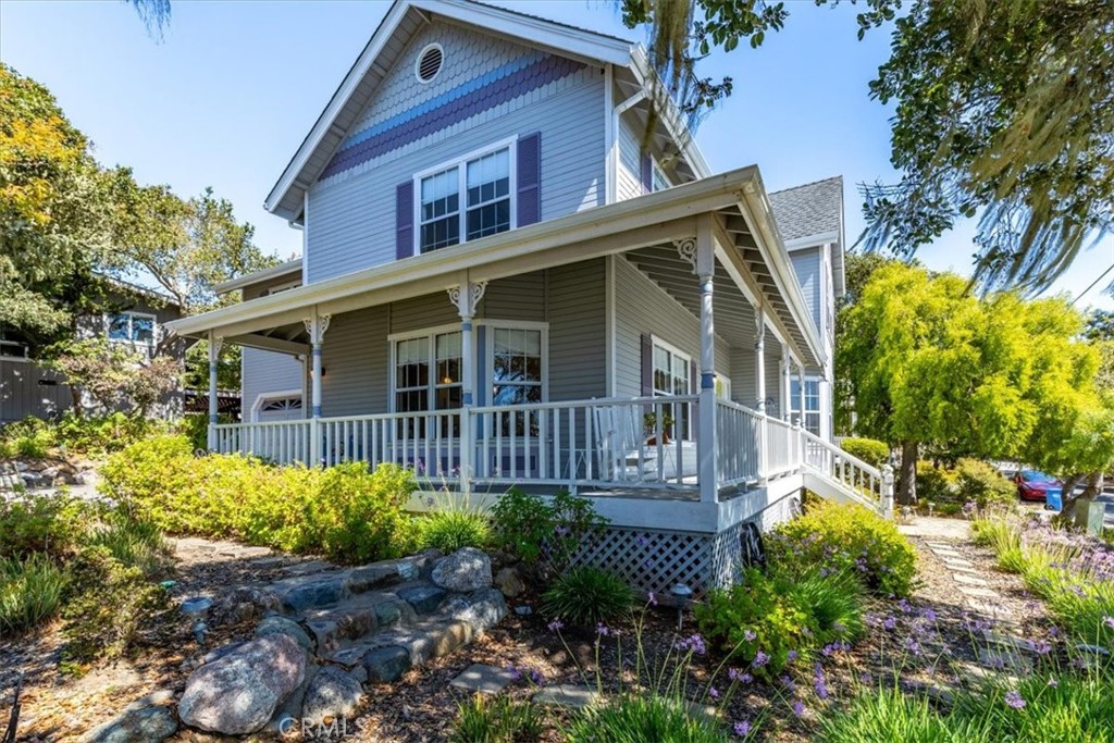 a view of a house with a yard and potted plants