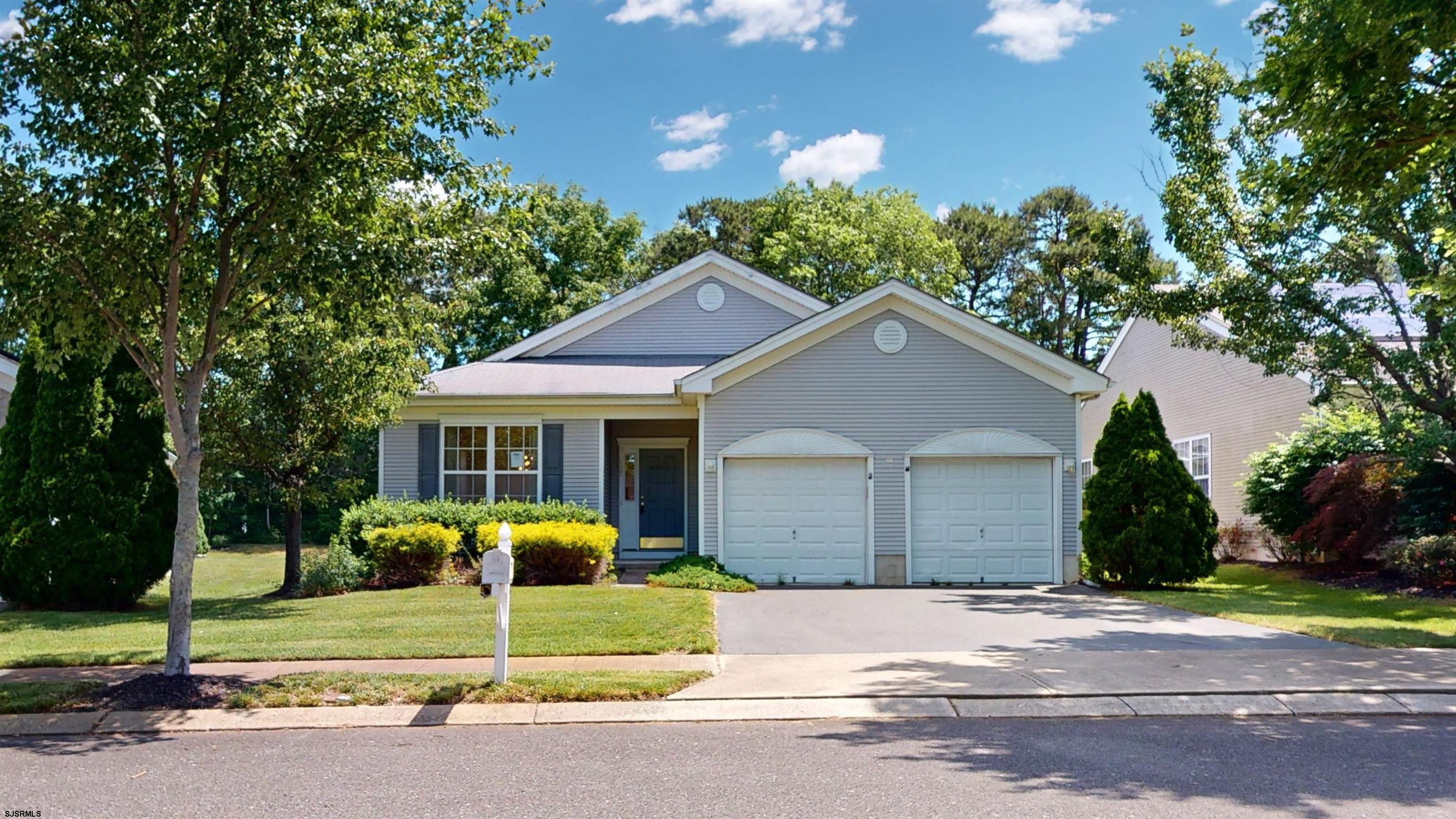 a house that has a tree in front of it