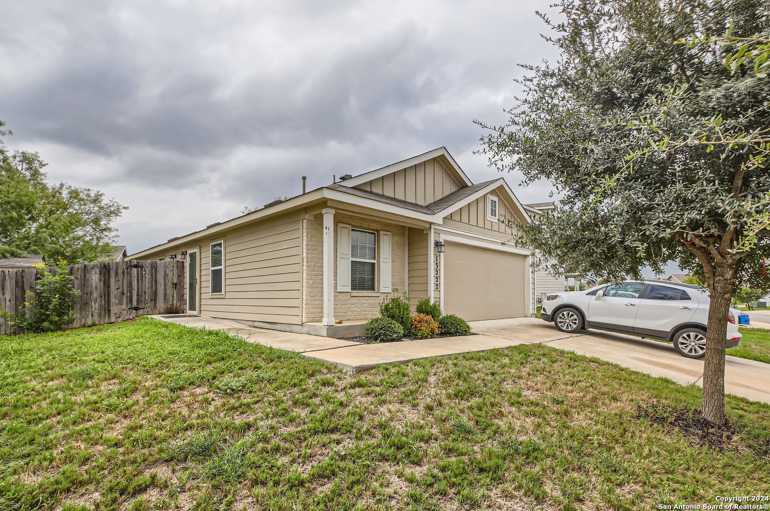 a front view of house with yard and green space