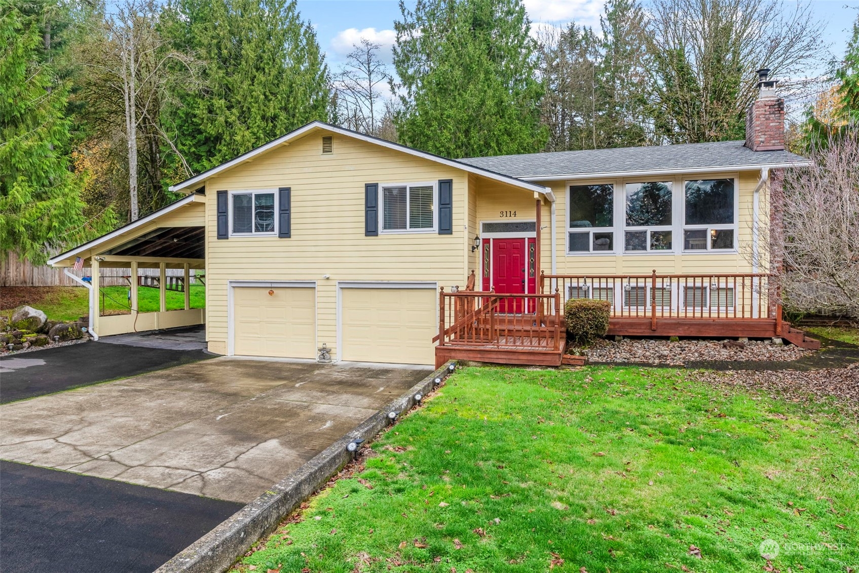 a view of a house with a yard and sitting area