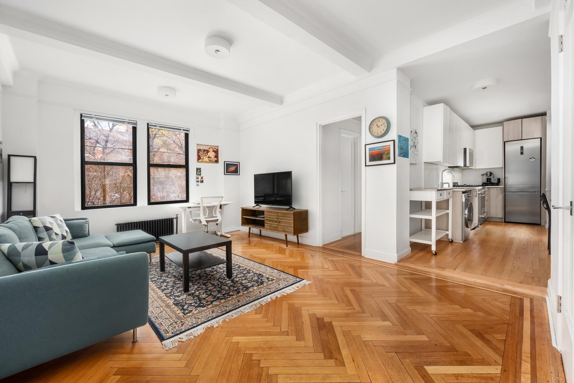 a living room with furniture a flat screen tv and a large window