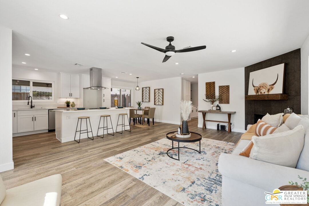 a living room with furniture and kitchen view