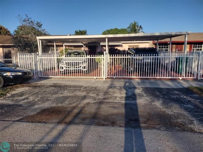 a view of a house with a fence