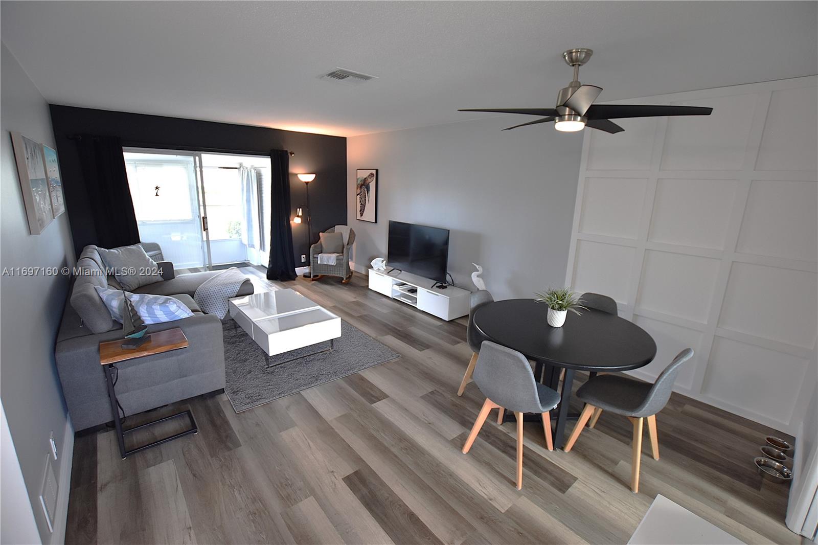 a living room with furniture and wooden floor