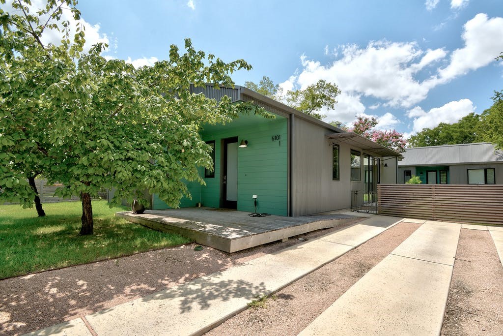 a front view of a house with a garden