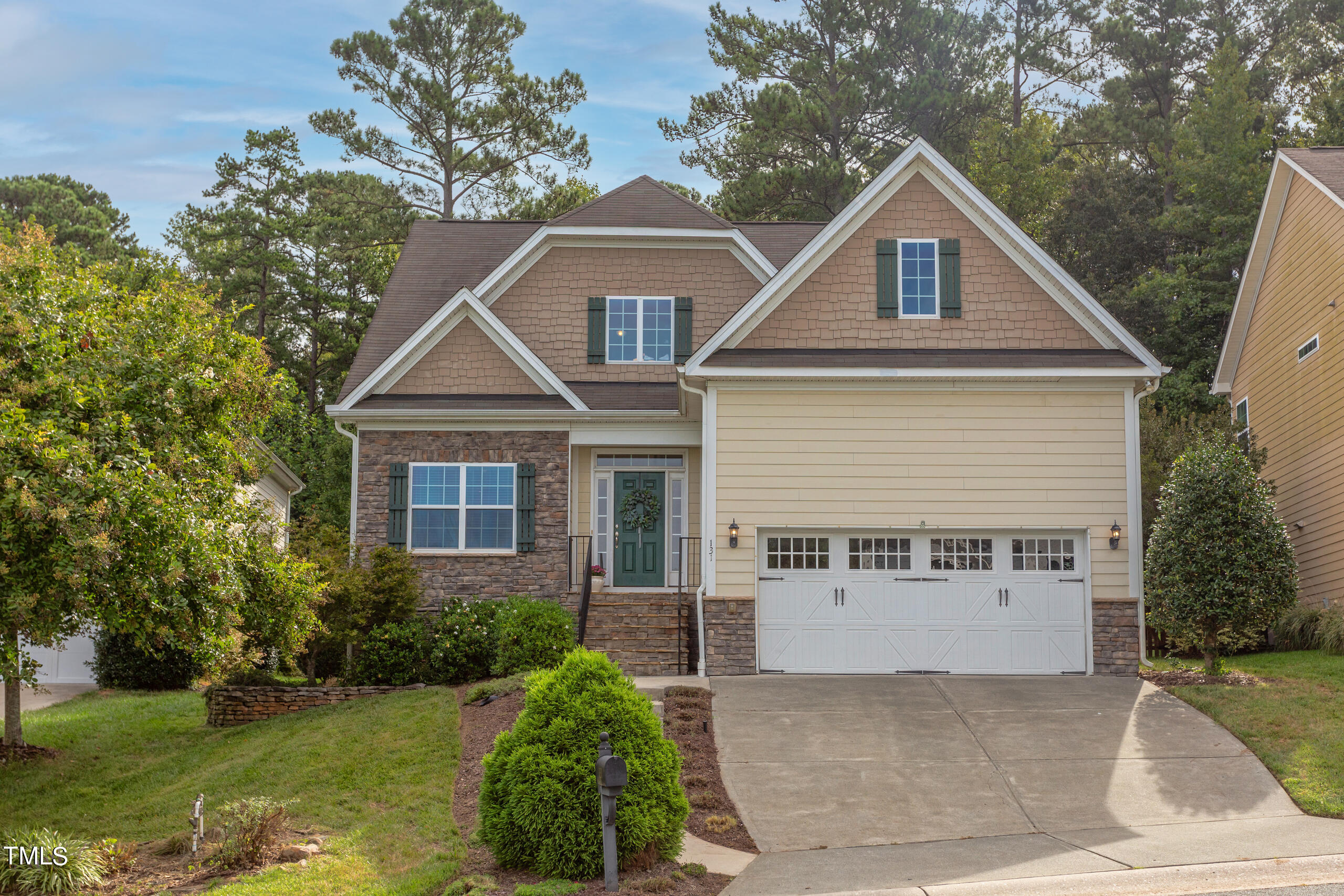 a front view of a house with a yard and garage