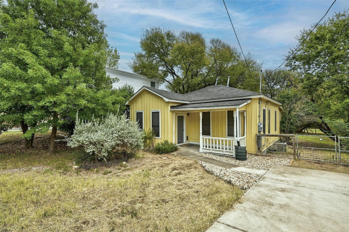 a front view of a house with a garden