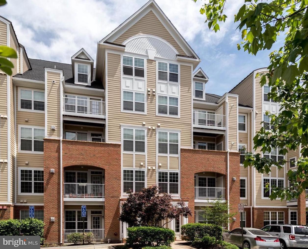 a front view of a residential apartment building with a yard