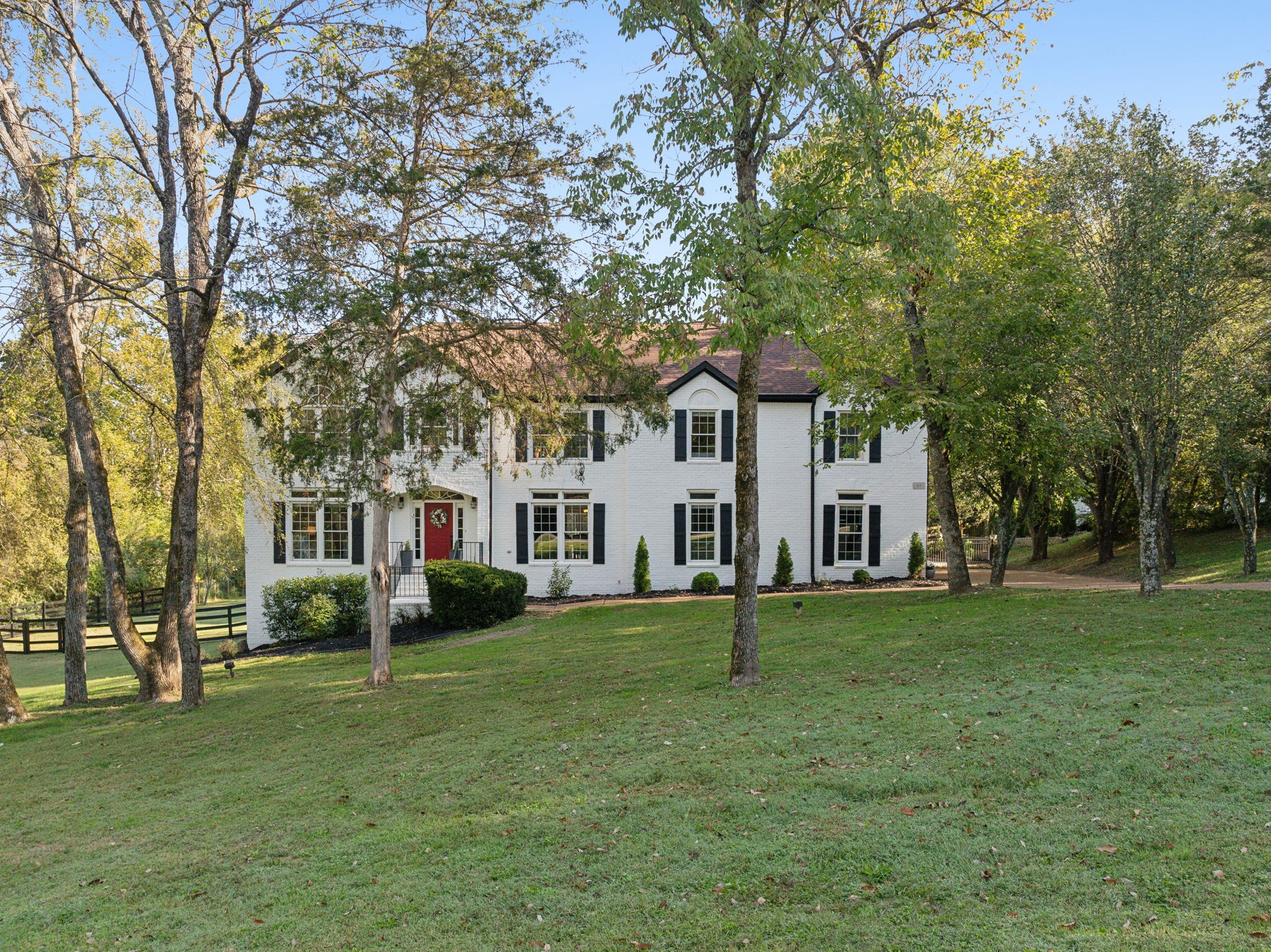 a front view of a house with a garden