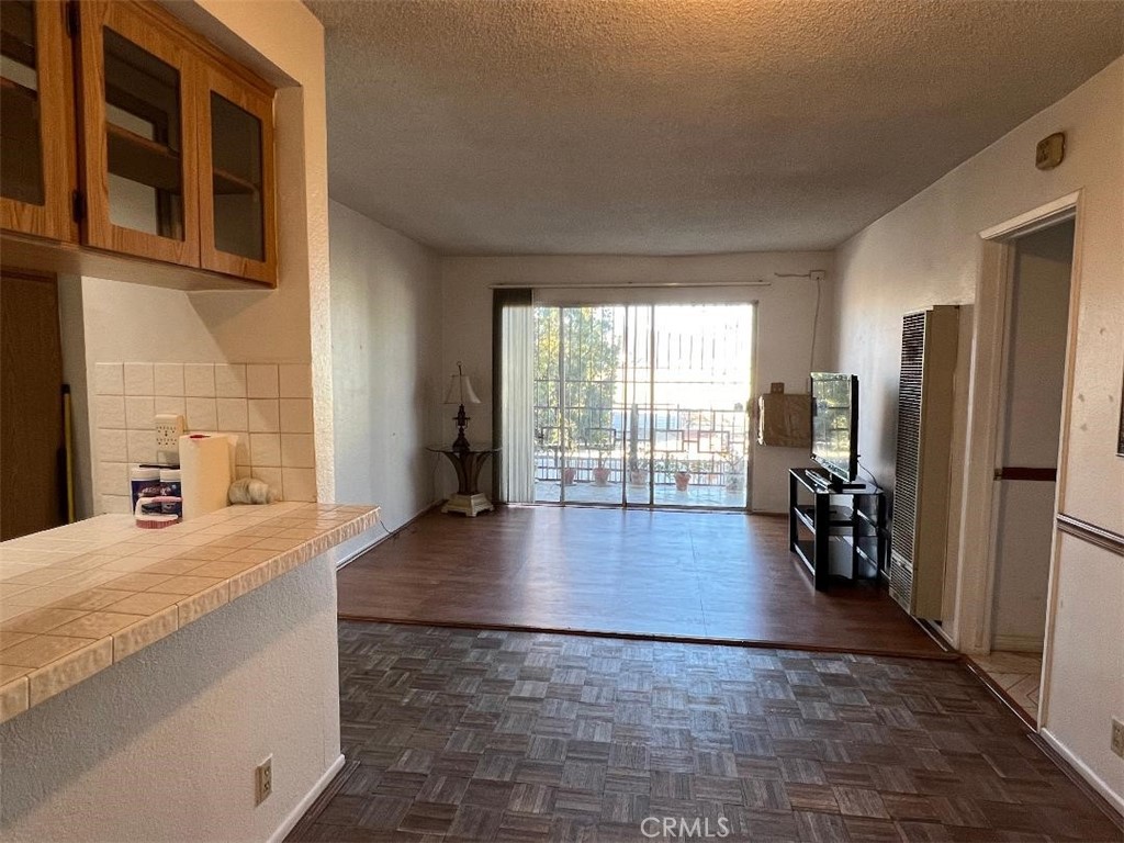 a view of a kitchen with refrigerator and windows