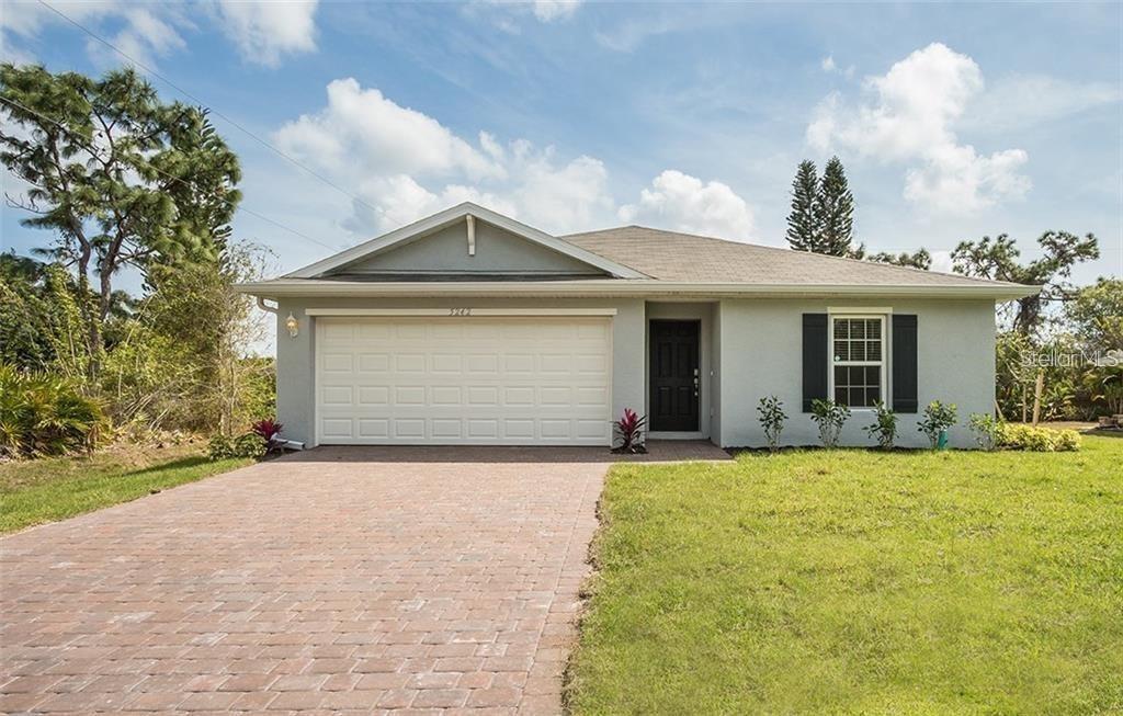 a front view of a house with a yard and garage