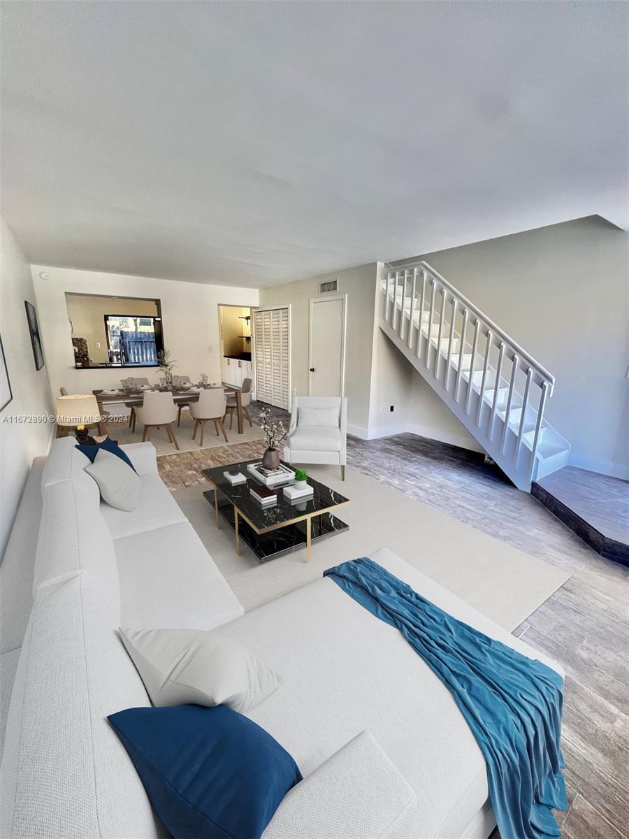 a living room with furniture rug and window