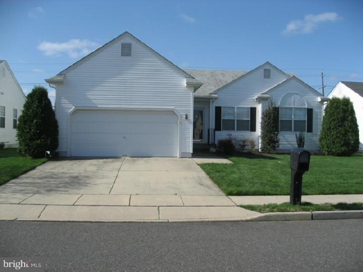 a front view of a house with a yard and a garage